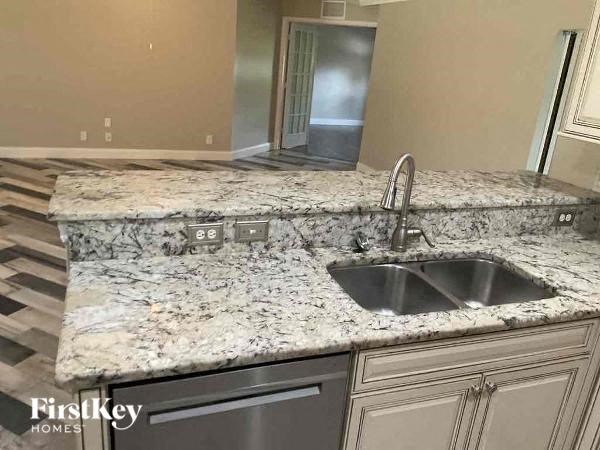 a kitchen with granite counter tops and a sink