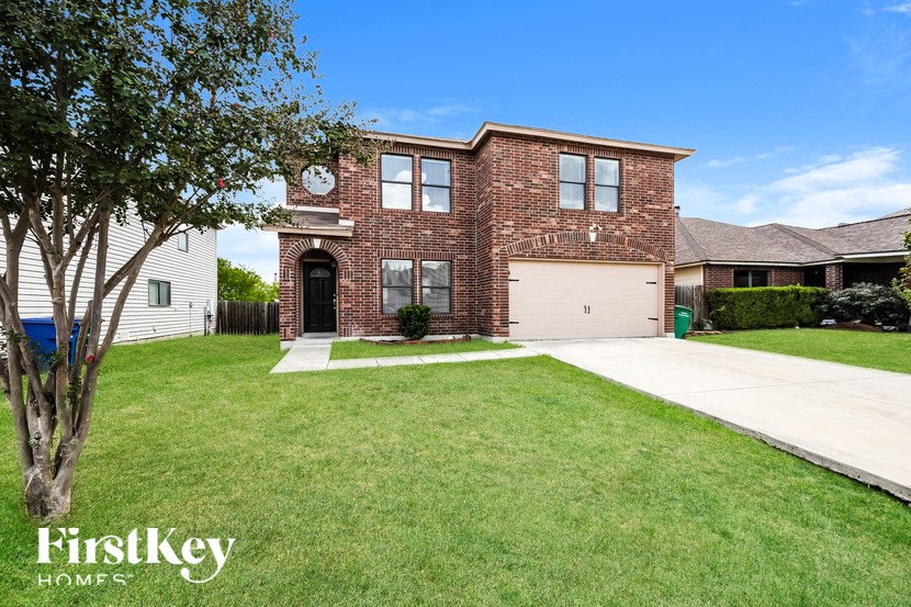 a brick house with a lawn in front of it