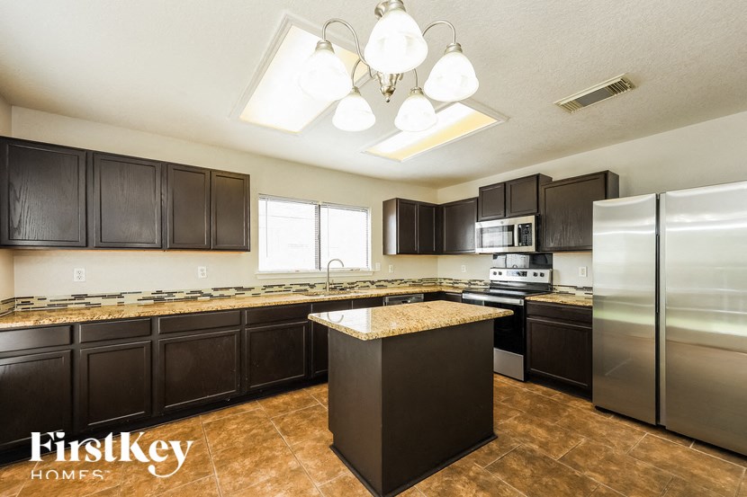 a kitchen with stainless steel appliances and granite counter tops