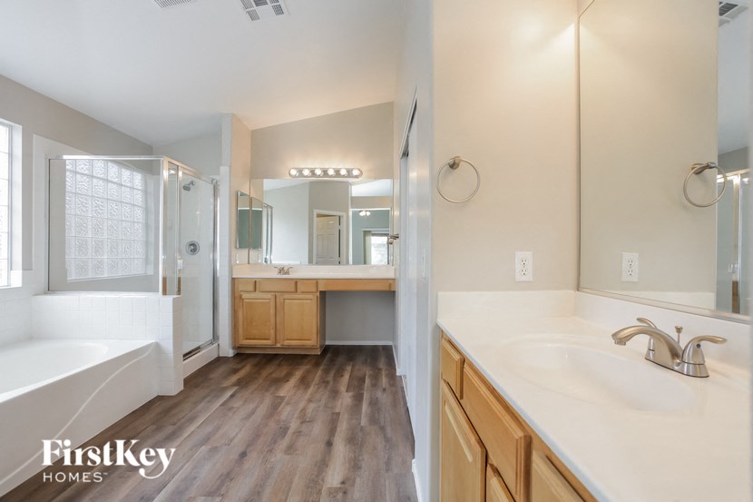 a bathroom with a sink and a tub and a mirror