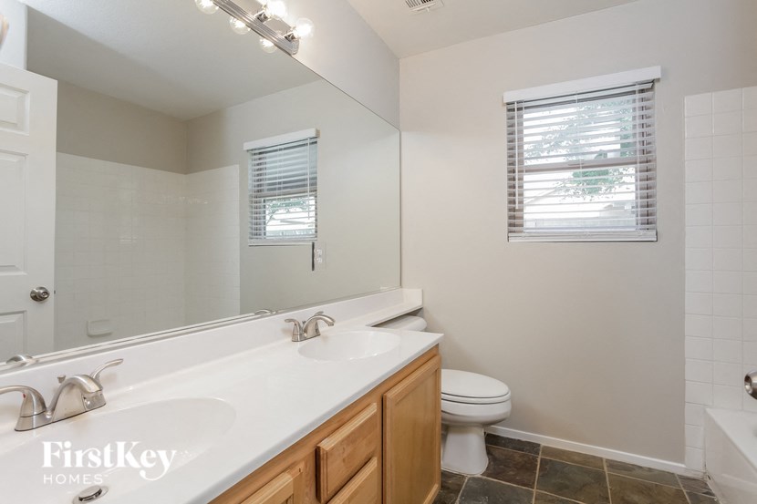 a bathroom with a toilet and a sink and a mirror