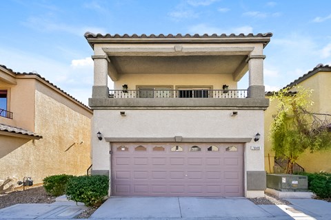 a house with a pink garage door in front of it