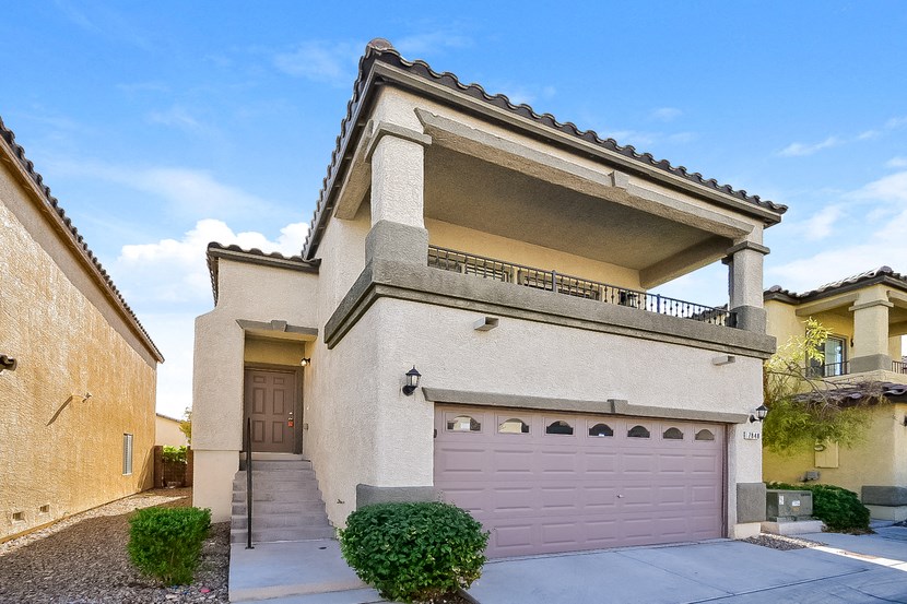 a white house with a pink garage door