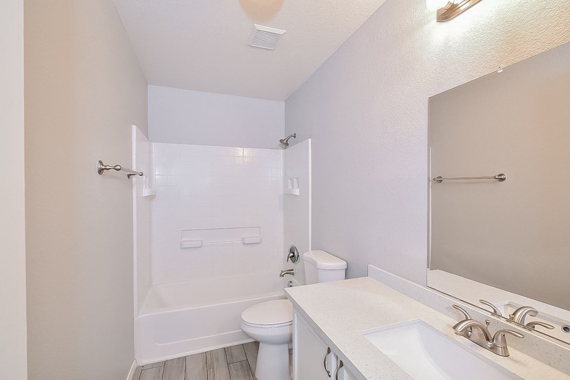 a bathroom with a sink and a toilet and a shower