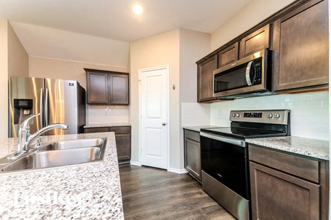 a kitchen with stainless steel appliances and granite counter tops