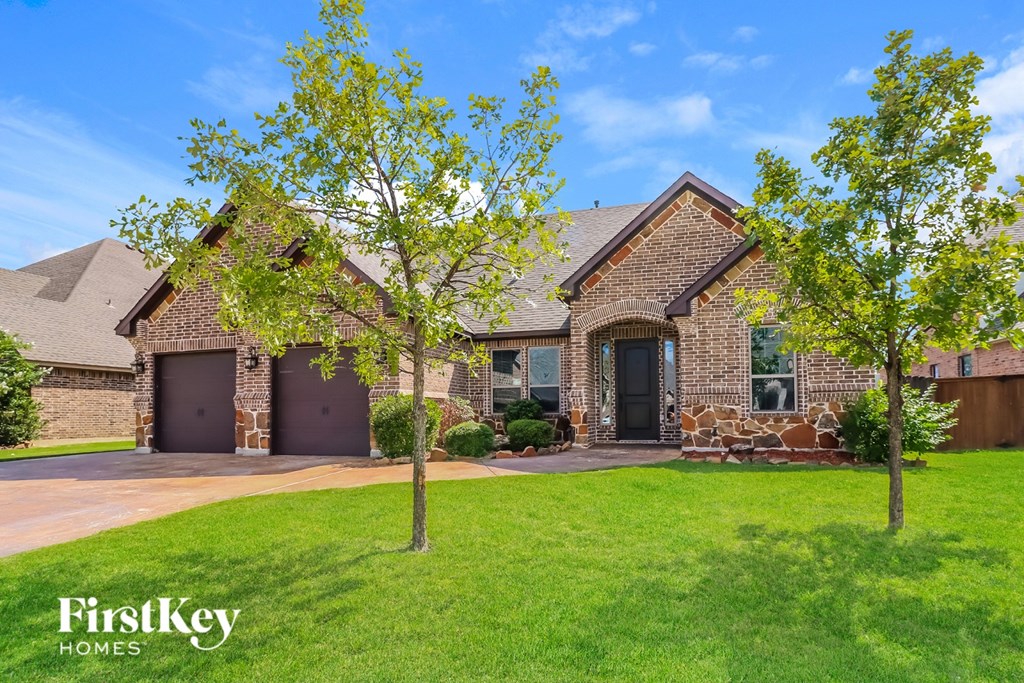 A house with a brick facade and a stone pillar in front.