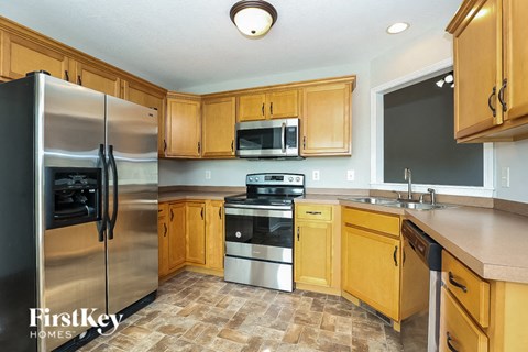 a kitchen with stainless steel appliances and wooden cabinets