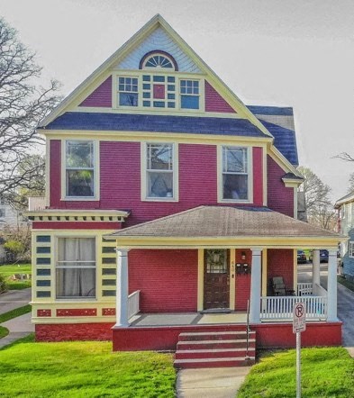 a red and yellow house with a blue roof