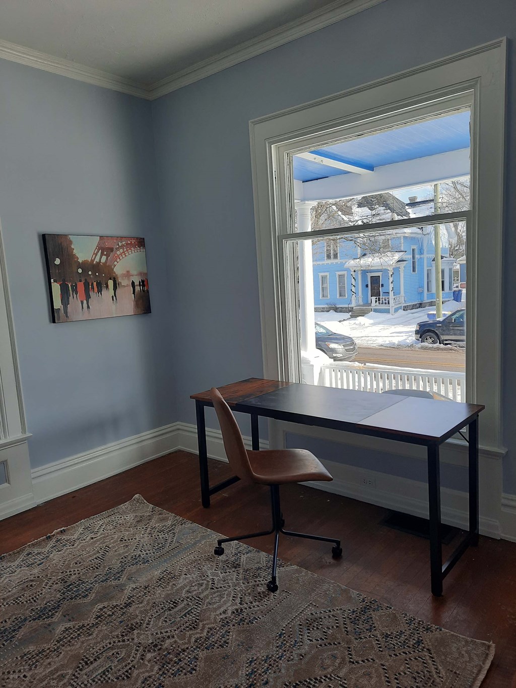 a home office with a desk and a window