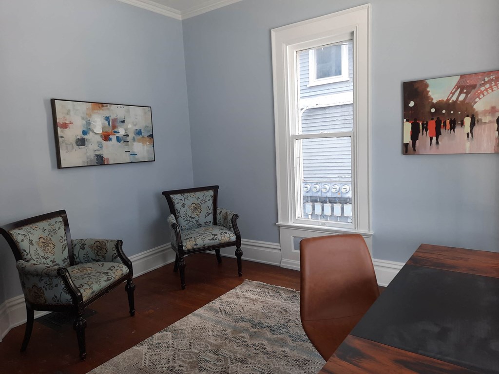 a dining room with a table and chairs and a window