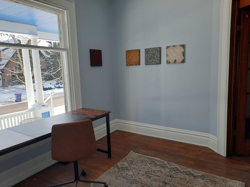 a home office with a desk and a window