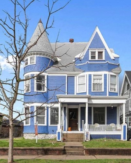 a blue house with a turret