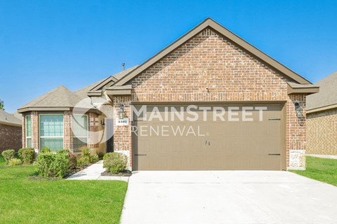 a house with a garage door with the name man street renewal on it