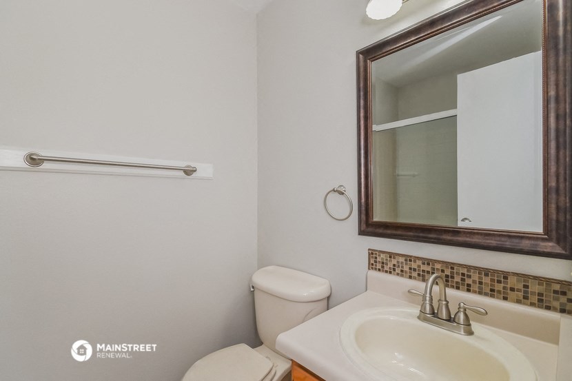 a bathroom with a sink and a mirror and a toilet