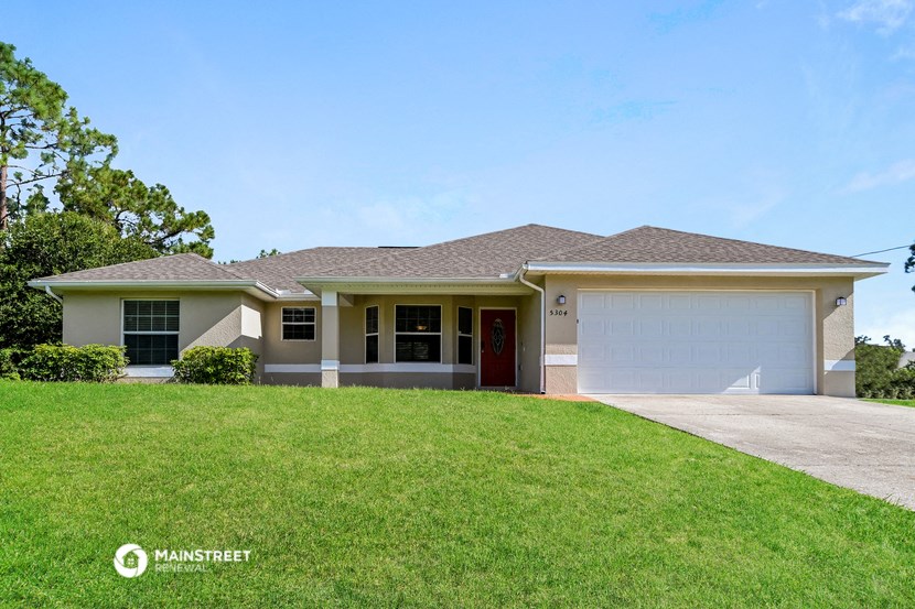 a house with a lawn and a garage door
