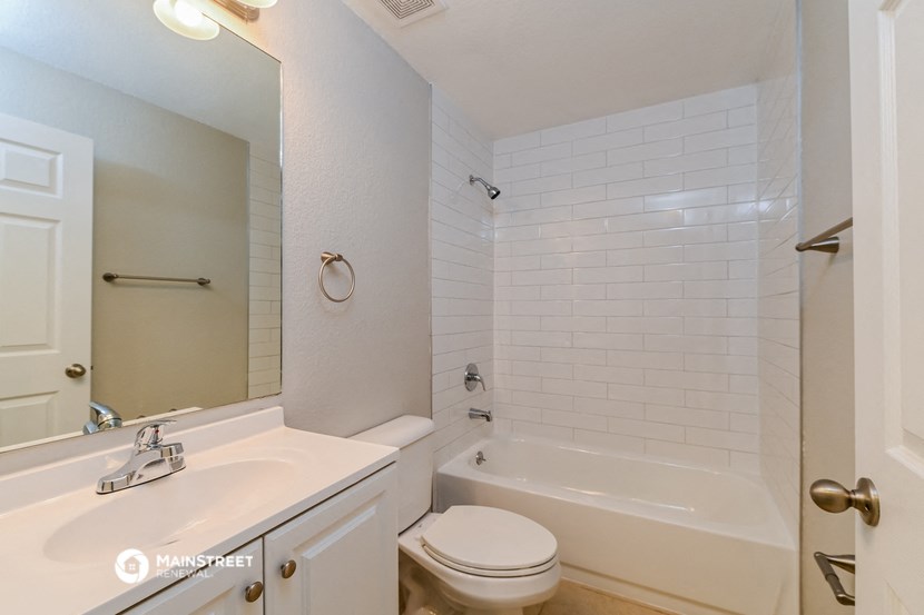 a bathroom with a sink toilet and a bath tub