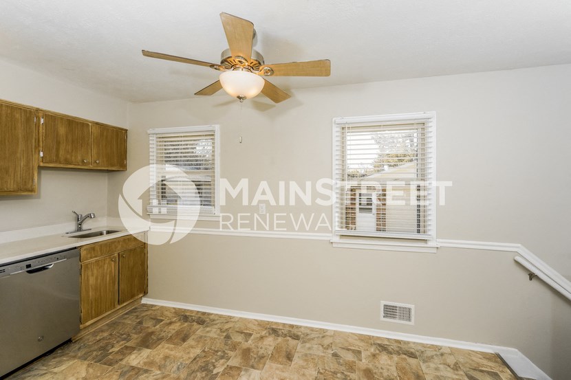 a kitchen with a ceiling fan and a sink