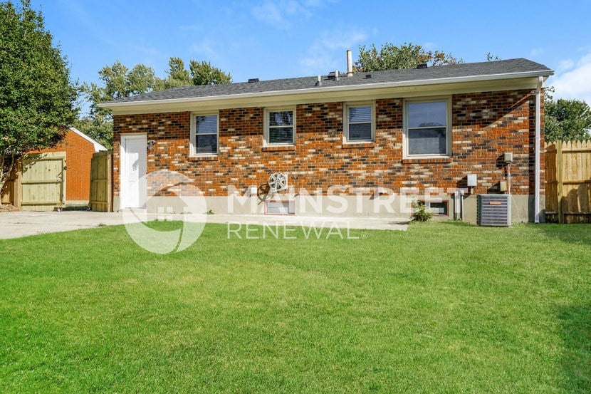 exterior view of a brick house with a lawn