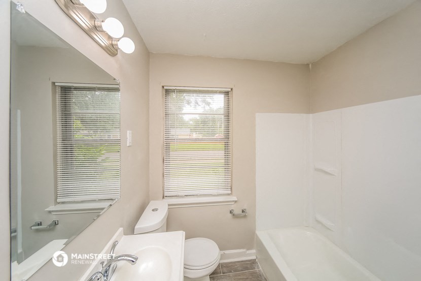 a bathroom with a sink toilet and a bath tub