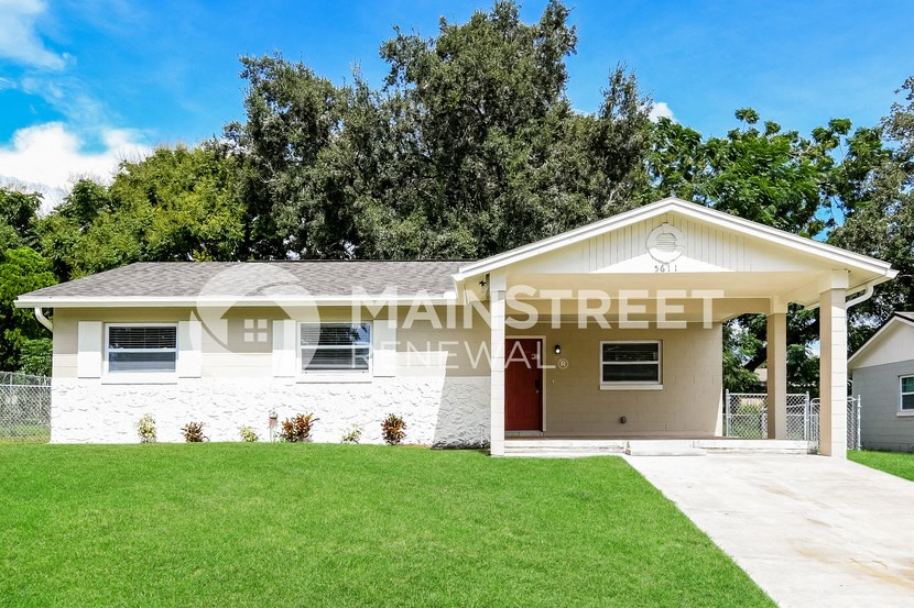 a small white house with a lawn in front of it