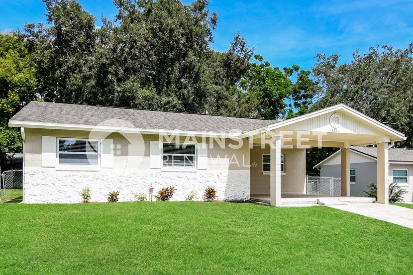 a white house with a lawn in front of it