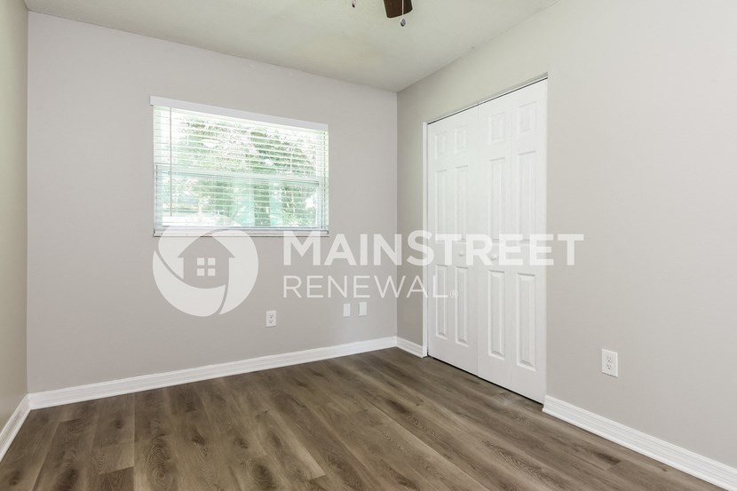 a bedroom with a closet and a door