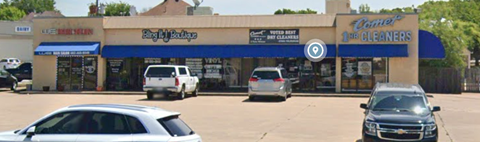 a car dealership with cars parked in a parking lot