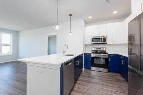 a kitchen with a white counter top and blue cabinets