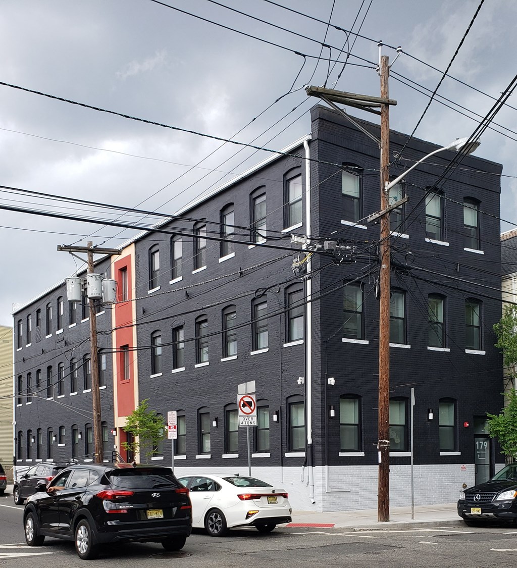 a city street with cars parked in front of a building