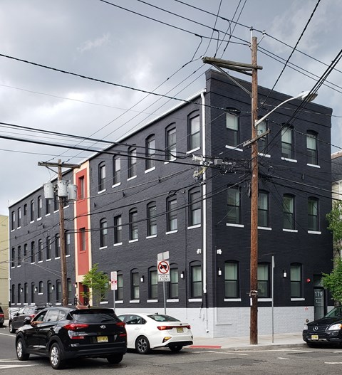 a city street with cars parked in front of a building