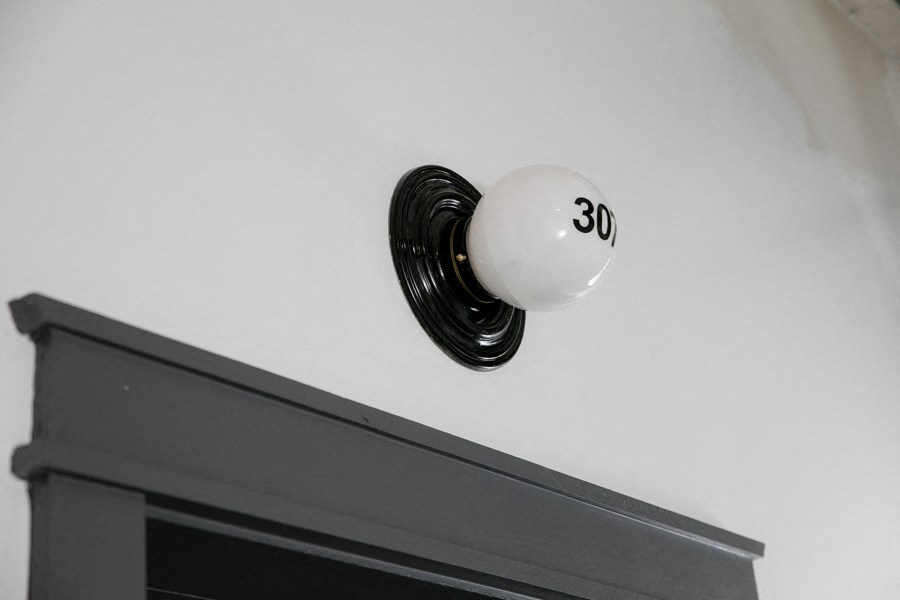 A white light bulb with the number 30 written on it.