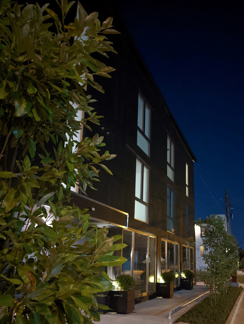 A building with windows and lights on at night.