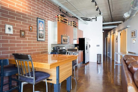 a kitchen and dining area in a room with a table and chairs