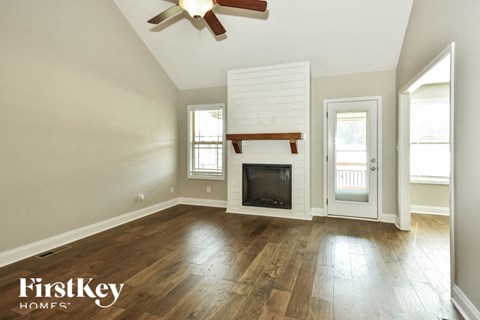 the living room has a fireplace and hardwood floors