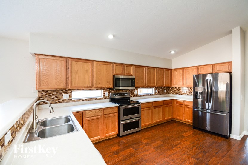 A kitchen with wooden cabinets and stainless steel appliances.