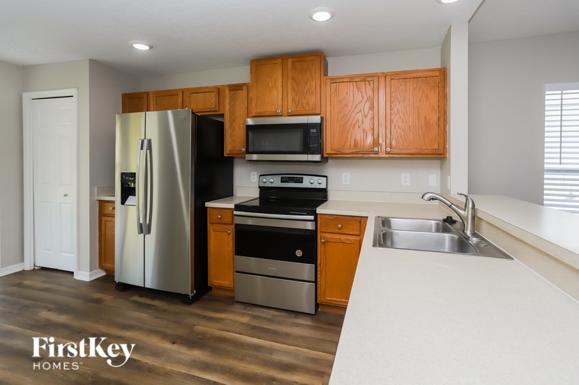 A kitchen with wooden cabinets and stainless steel appliances.