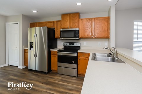 A kitchen with wooden cabinets and stainless steel appliances.