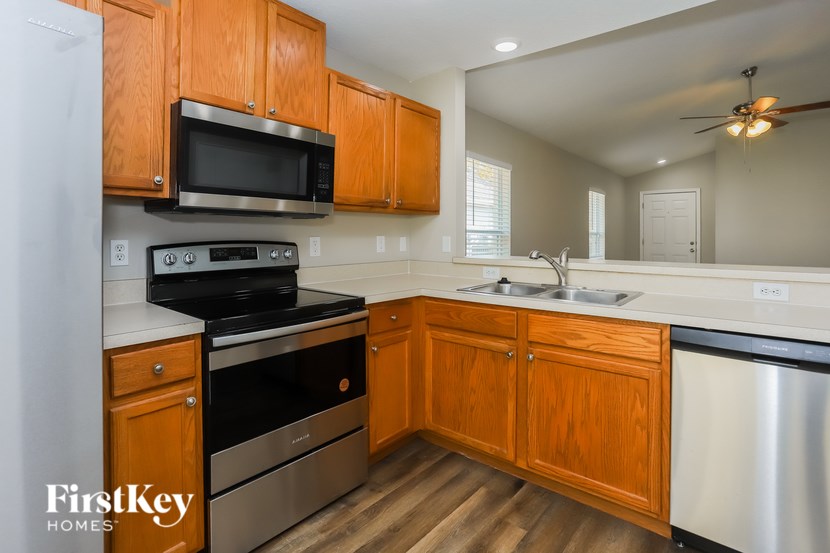 A kitchen with wooden cabinets and stainless steel appliances.