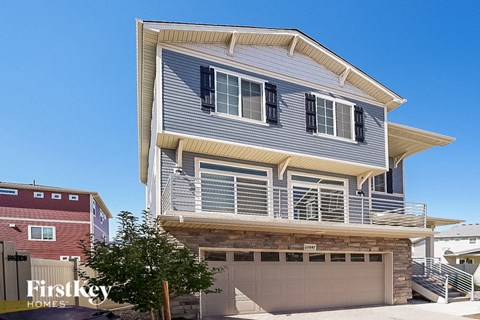 a blue and white house with a garage