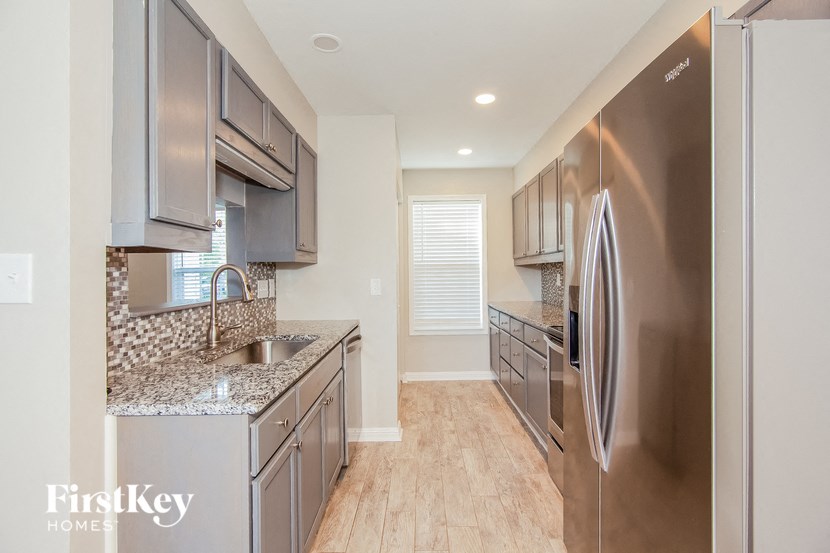a modern kitchen with stainless steel appliances and granite counter tops