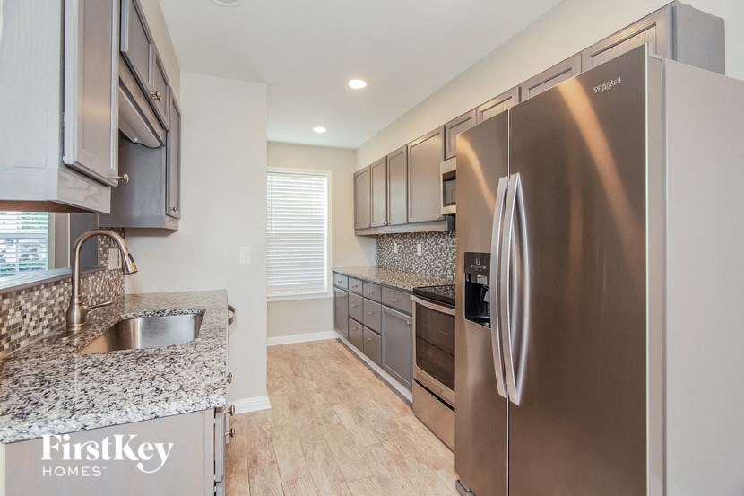 a modern kitchen with stainless steel appliances and granite counter tops