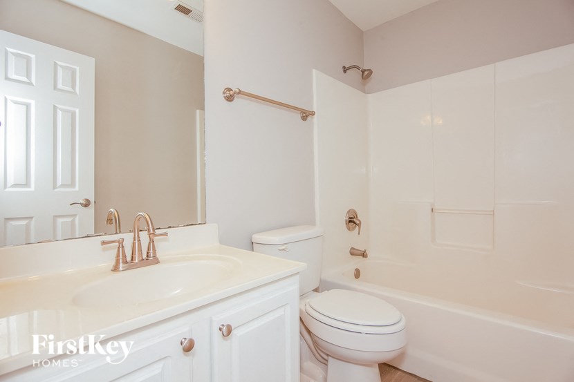 a bathroom with a sink toilet and a tub