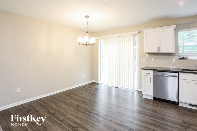 an empty kitchen and living room with wood flooring