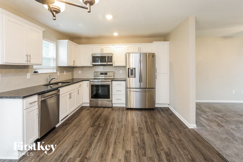a kitchen with stainless steel appliances and white cabinets