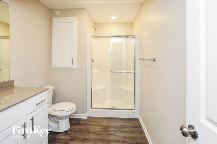 a bathroom with a toilet and a shower