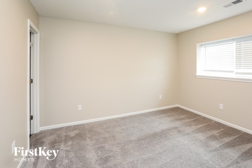 a room with carpet and a window and a door