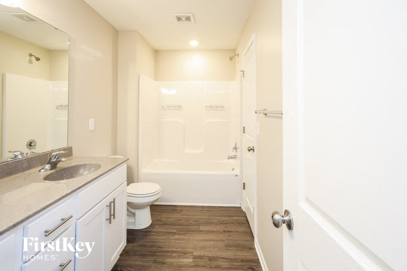 a bathroom with a toilet and a sink and a shower