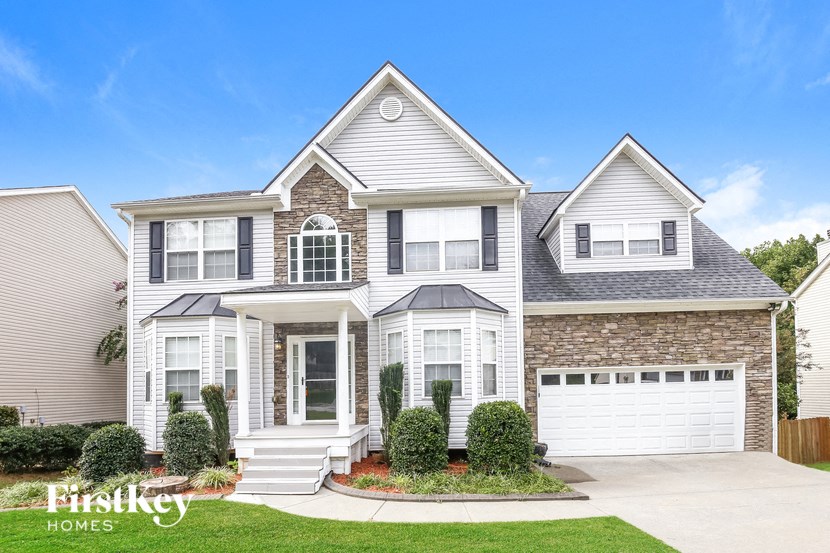 a white house with white shutters and a gray roof