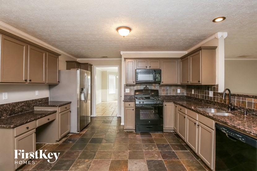 a kitchen with granite counter tops and stainless steel appliances
