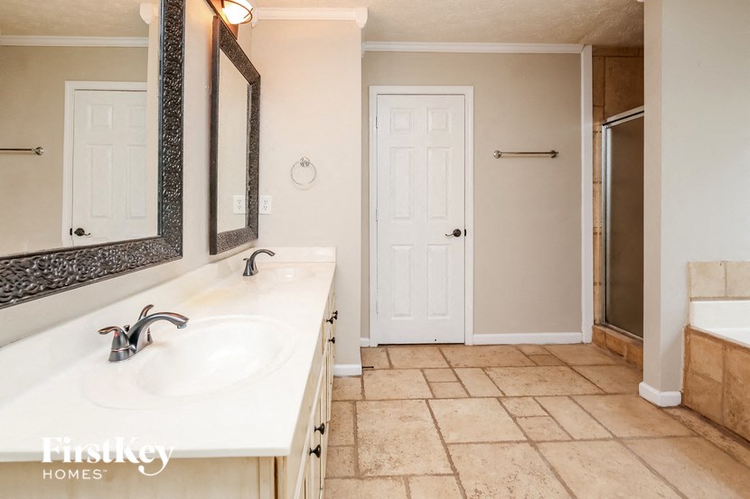 a bathroom with a sink and a mirror and a shower